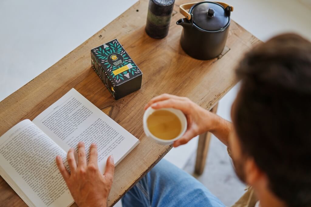 Man Enjoying Our Lion's Mane Green Tea while Reading