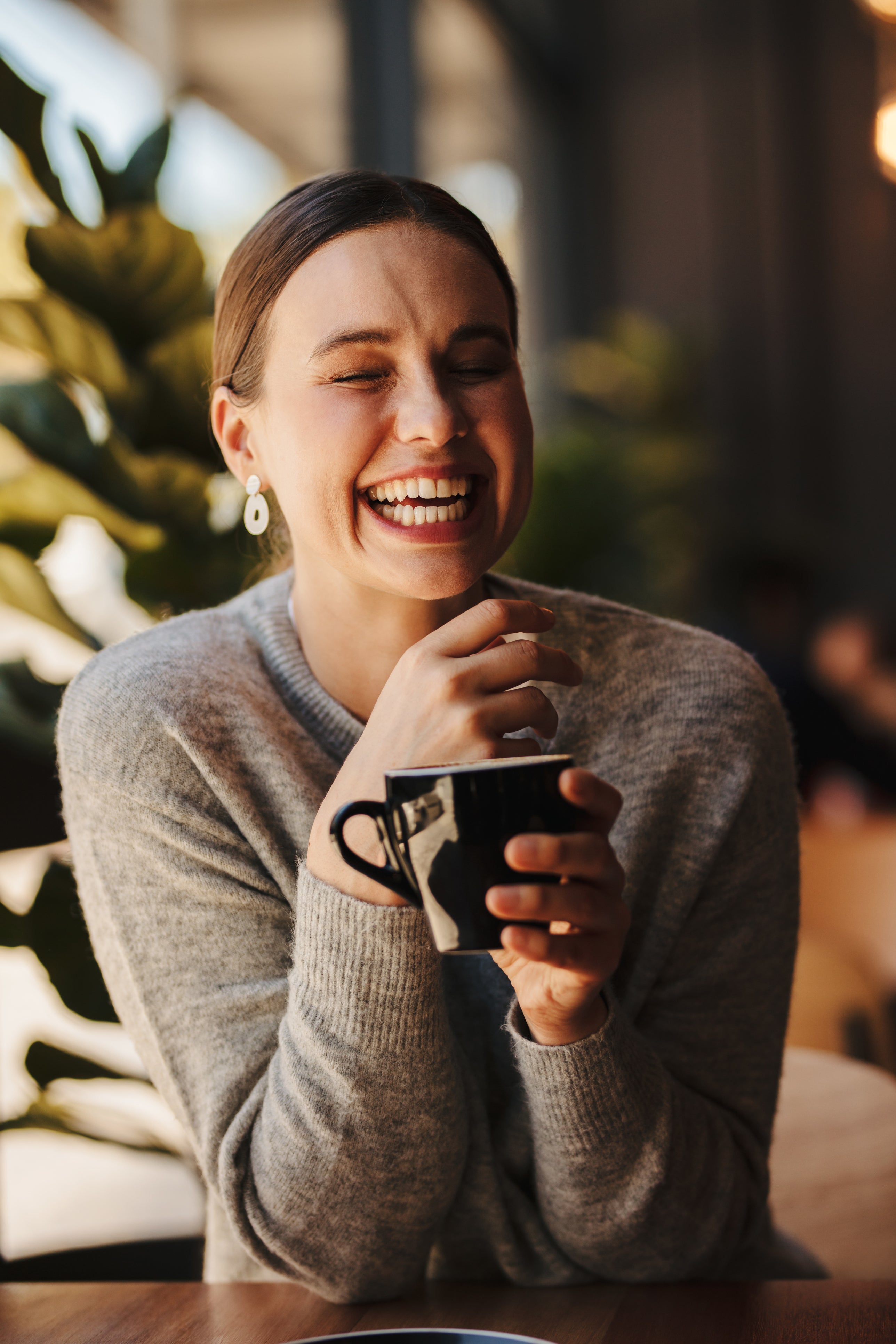 Cheerful woman drinking mushroom coffee