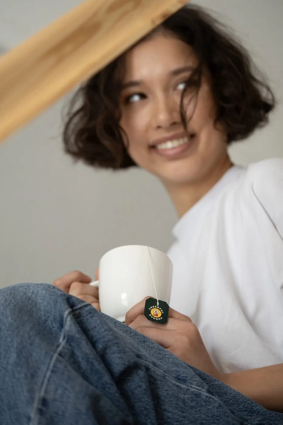 Smiling woman relaxing on the sofa with her morning mug